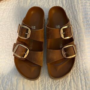 Big buckle Birkenstocks.  Brown / tan color.